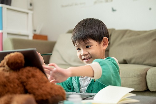Preschooler studying online and doing screen activities