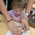 Teacher helping toddler Amelia